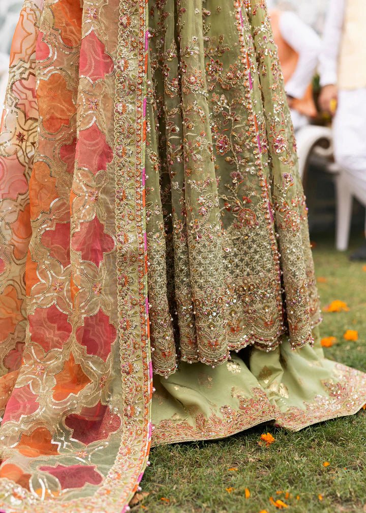 Model wearing Kanwal Malik Maahi Wedding Festive '24 AYAT, a stunning green ensemble with vibrant floral embroidery and an ornate dupatta, perfect for weddings. Available for Pakistani clothes online in the UK.