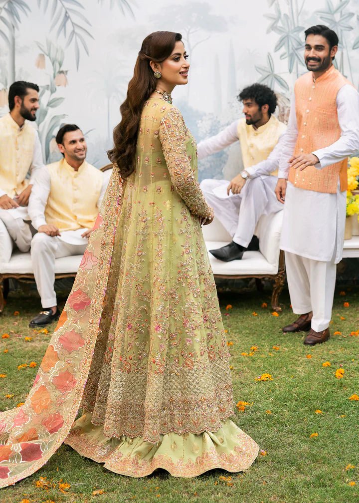 Model wearing Kanwal Malik Maahi Wedding Festive '24 AYAT, a stunning green ensemble with vibrant floral embroidery and an ornate dupatta, perfect for weddings. Available for Pakistani clothes online in the UK.