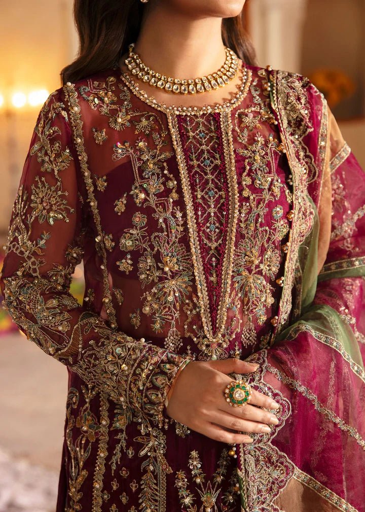 Model wearing Kanwal Malik Maahi Wedding Festive '24 FALAK, a deep maroon ensemble with intricate gold embellishments, perfect for weddings. Available for Pakistani clothes online in the UK.