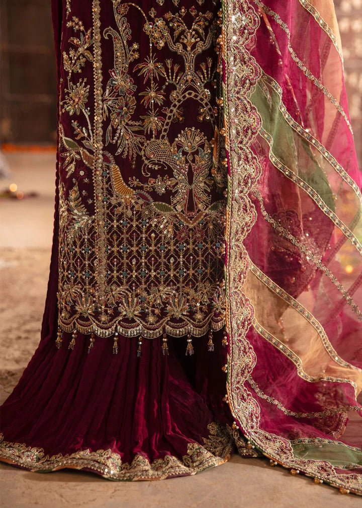 Model wearing Kanwal Malik Maahi Wedding Festive '24 FALAK, a deep maroon ensemble with intricate gold embellishments, perfect for weddings. Available for Pakistani clothes online in the UK.