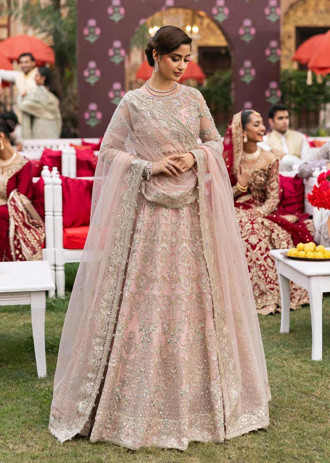 Model wearing Kanwal Malik Maahi Wedding Festive '24 NAGEEN, a soft pink bridal dress with intricate silver embellishments, ideal for weddings. Available for Pakistani clothes online in the UK.