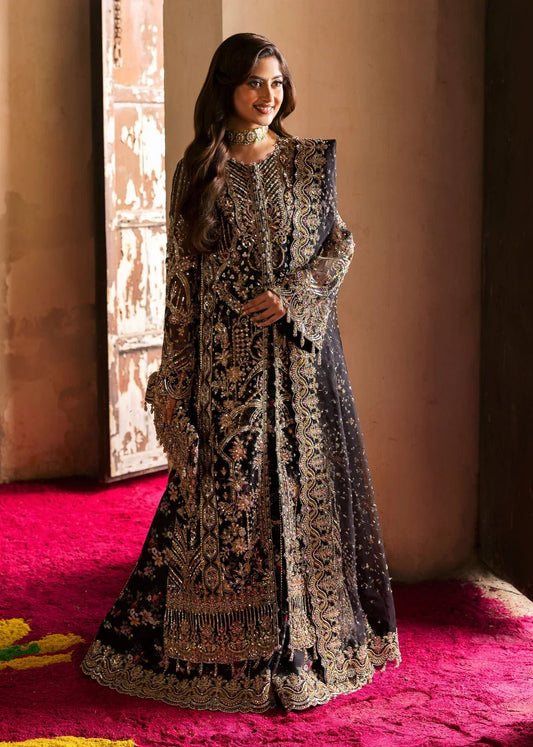 Model wearing Kanwal Malik Maahi Wedding Festive '24 ZAIB, a luxurious black ensemble adorned with intricate gold and silver embellishments, perfect for weddings. Available for Pakistani clothes online in the UK.