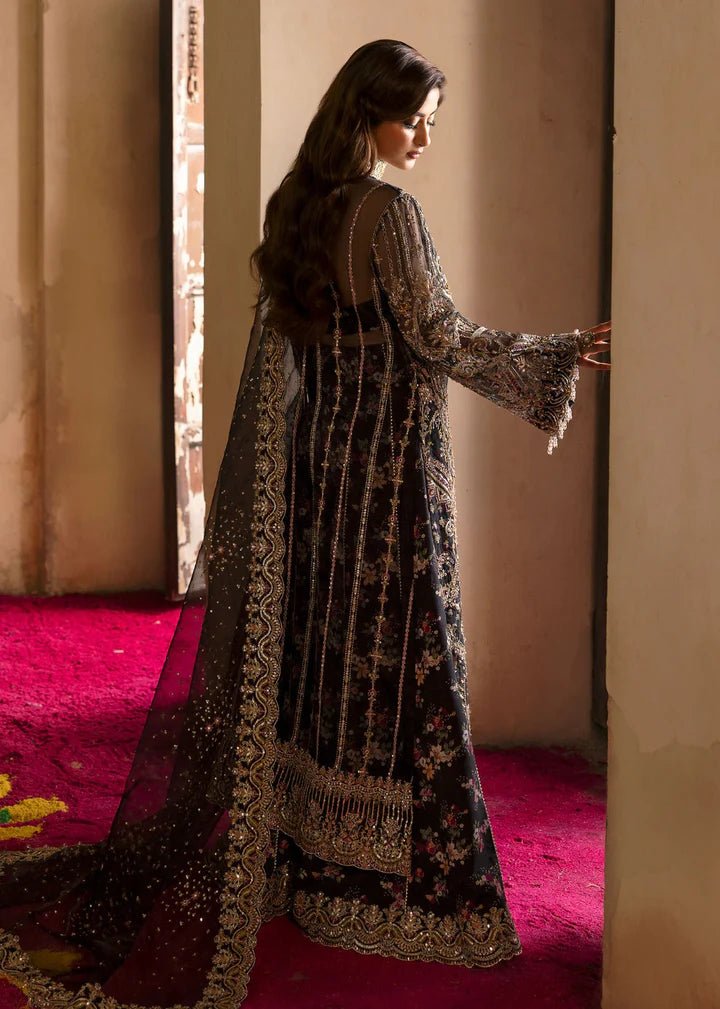 Model wearing Kanwal Malik Maahi Wedding Festive '24 ZAIB, a luxurious black ensemble adorned with intricate gold and silver embellishments, perfect for weddings. Available for Pakistani clothes online in the UK.