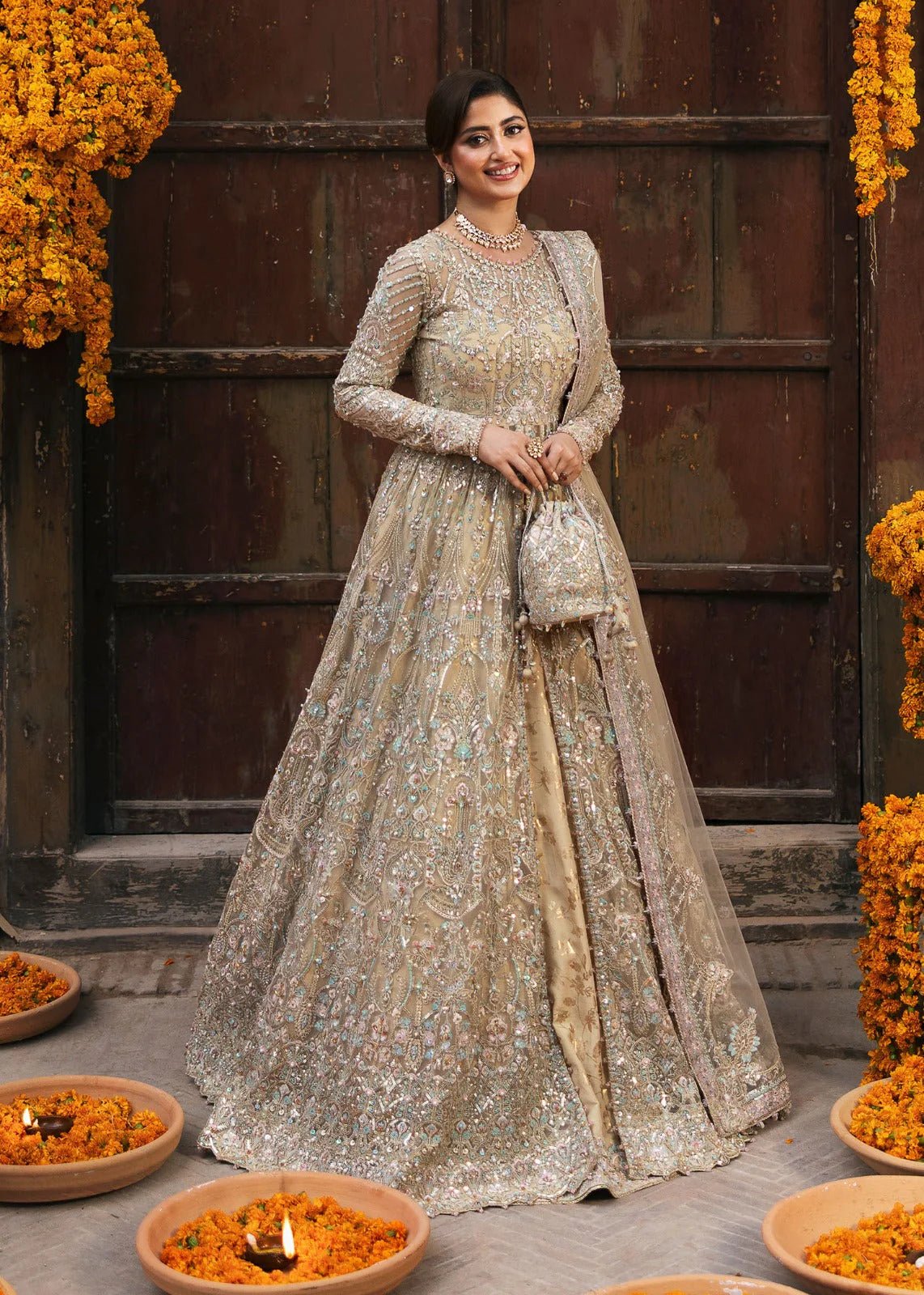 Model wearing Kanwal Malik Maahi Wedding Festive '24 ZOFIA, a luxurious champagne - colored bridal dress adorned with intricate embellishments, perfect for weddings. Available for Pakistani clothes online in the UK.