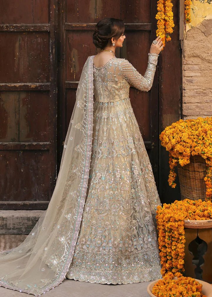 Model wearing Kanwal Malik Maahi Wedding Festive '24 ZOFIA, a luxurious champagne - colored bridal dress adorned with intricate embellishments, perfect for weddings. Available for Pakistani clothes online in the UK.