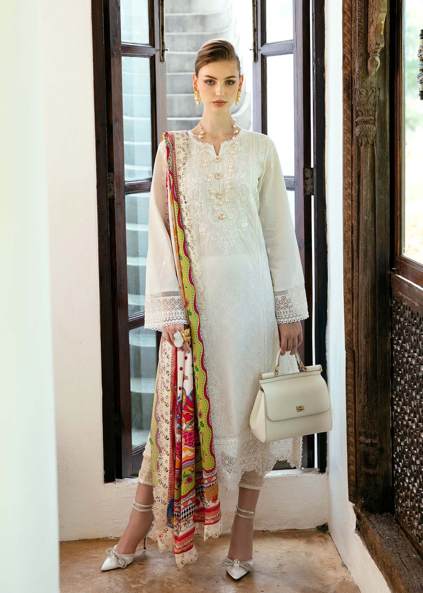 Model wearing a white Cerise dress from Kanwal Malik's Mayal Luxury Lawn collection, featuring vibrant multi - colored accents. Perfect for Pakistani clothes online in the UK.