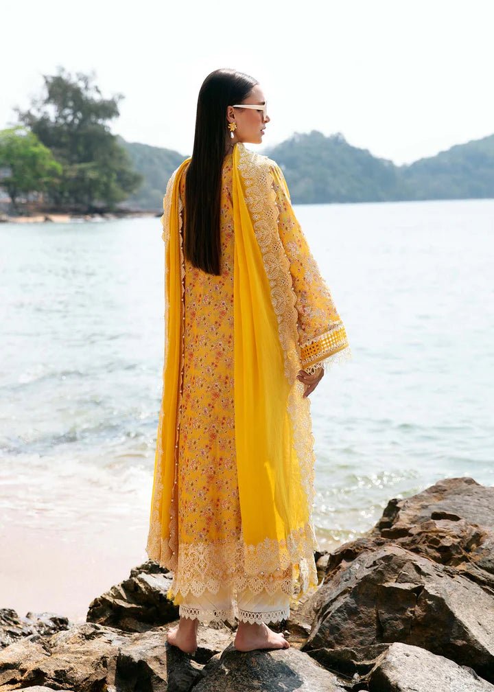 Model wearing a yellow Elara dress from Kanwal Malik's Mayal Luxury Lawn collection, featuring delicate lace detailing and floral patterns. Perfect for Pakistani clothes online in the UK.