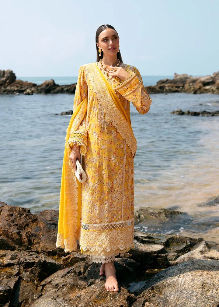 Model wearing a yellow Elara dress from Kanwal Malik's Mayal Luxury Lawn collection, featuring delicate lace detailing and floral patterns. Perfect for Pakistani clothes online in the UK.