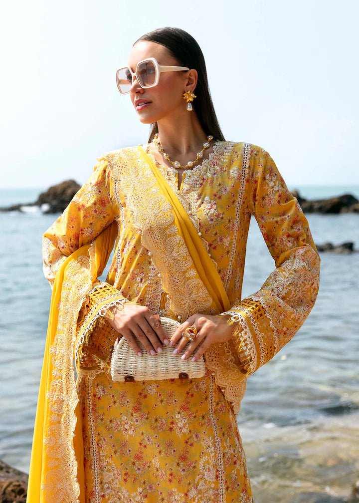 Model wearing a yellow Elara dress from Kanwal Malik's Mayal Luxury Lawn collection, featuring delicate lace detailing and floral patterns. Perfect for Pakistani clothes online in the UK.