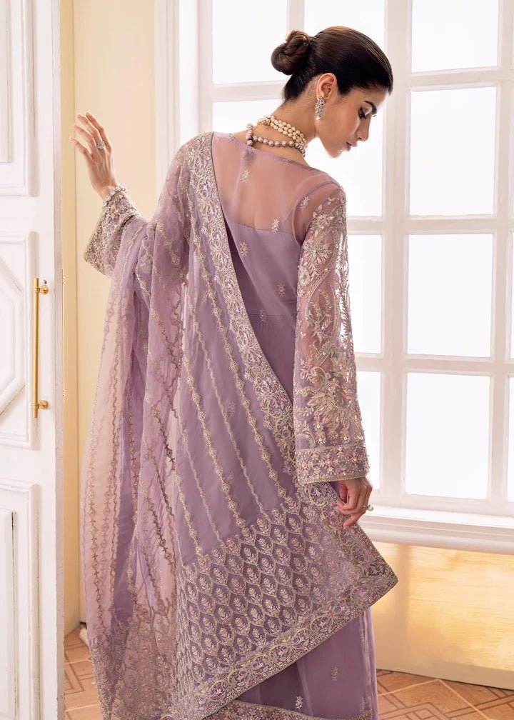 Model wearing a lilac NAIRA dress from Kanwal Malik's MIRHA II '23 collection. Pakistani designer clothes available online in the UK, perfect for weddings.