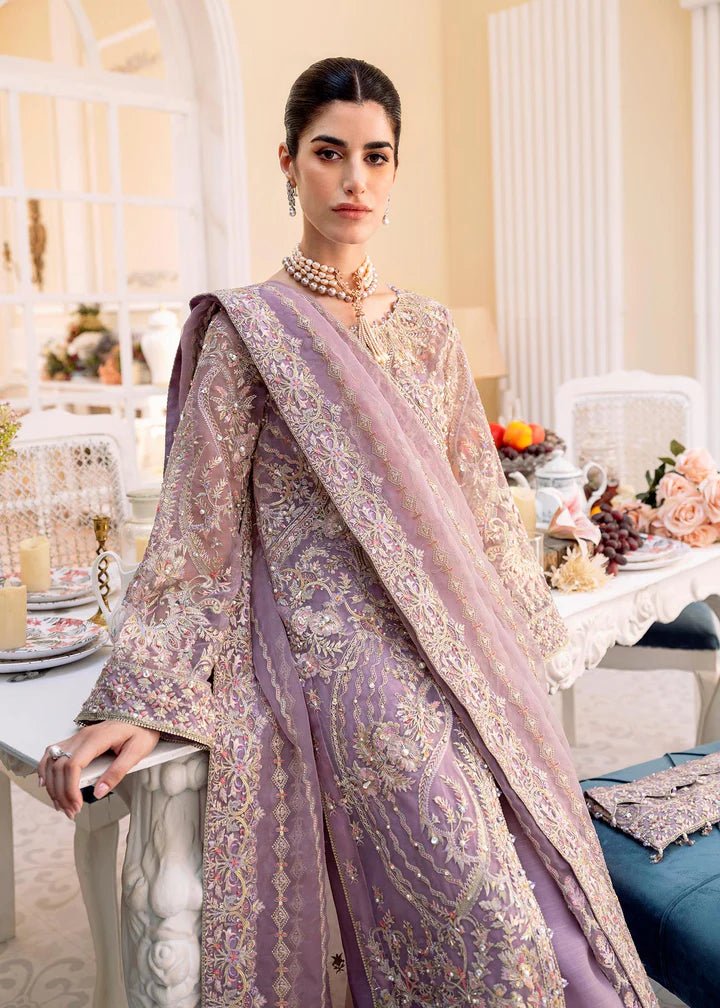 Model wearing a lilac NAIRA dress from Kanwal Malik's MIRHA II '23 collection. Pakistani designer clothes available online in the UK, perfect for weddings.