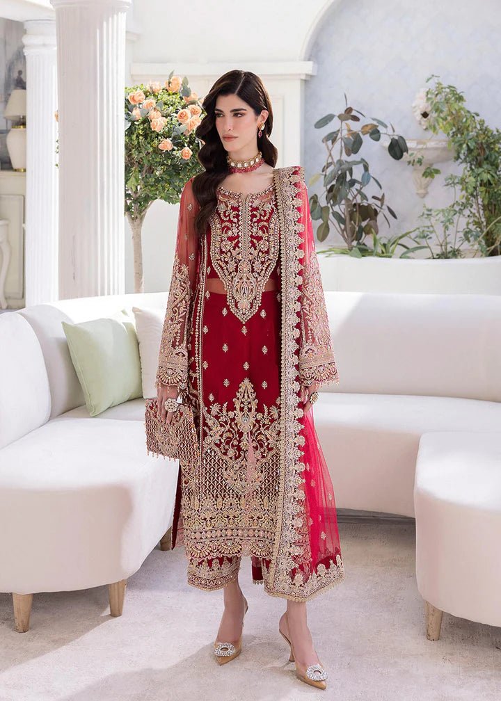 Model wearing Kanwal Malik Crimson dress, rich red with gold detailing, elegant Pakistani clothes UK.