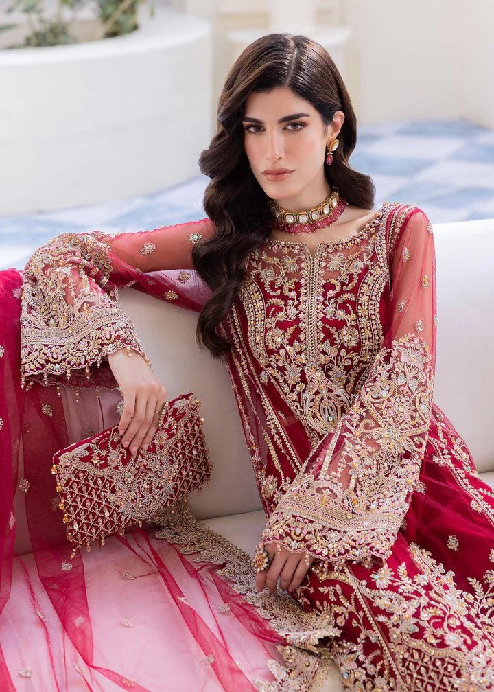 Model in Kanwal Malik MIRHA III Eid 24 Crimson dress, red suit with golden embriodery enhancing Pakistani clothes online in the UK.