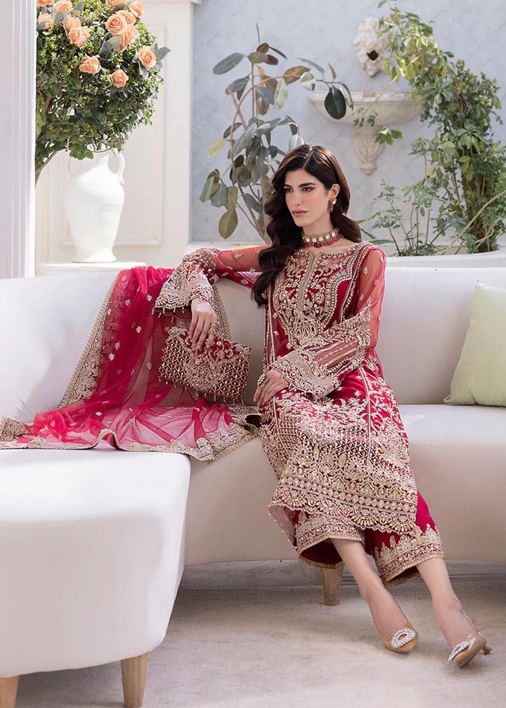 Model in Kanwal Malik MIRHA III Eid 24 Crimson dress, red suit with golden embriodery enhancing Pakistani clothes online in the UK.