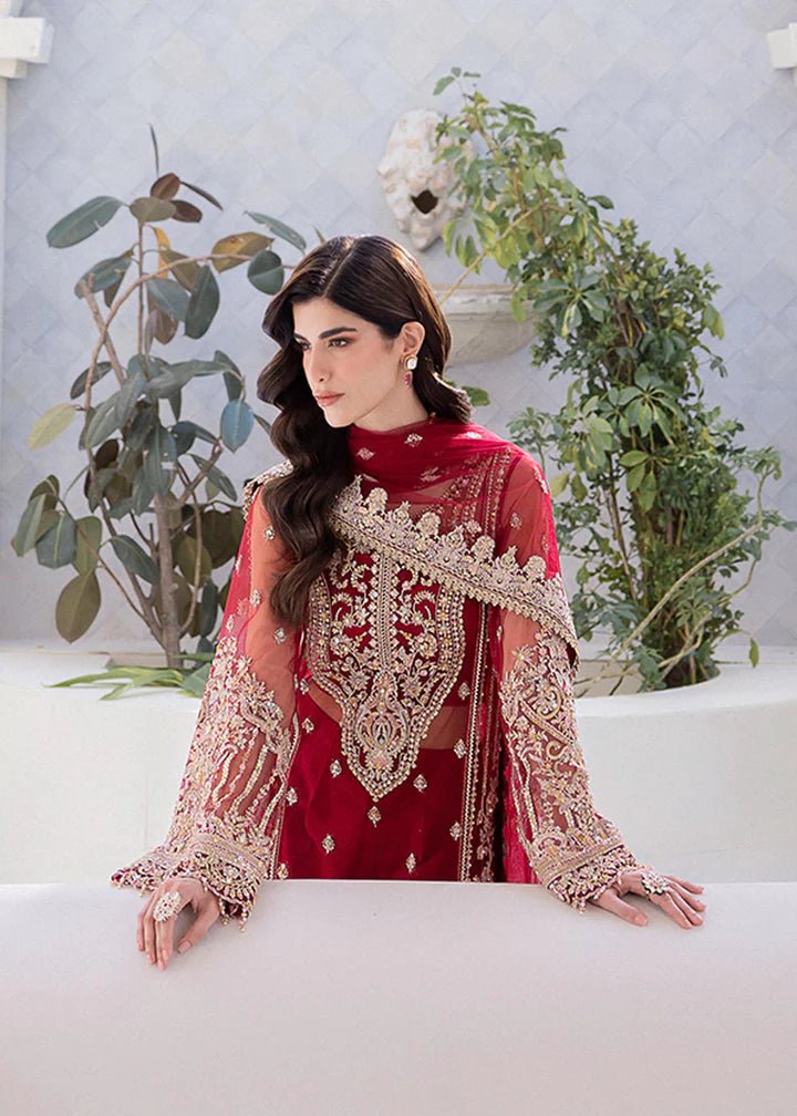 Model in Kanwal Malik MIRHA III Eid 24 Crimson dress, red suit with golden embriodery enhancing Pakistani clothes online in the UK.