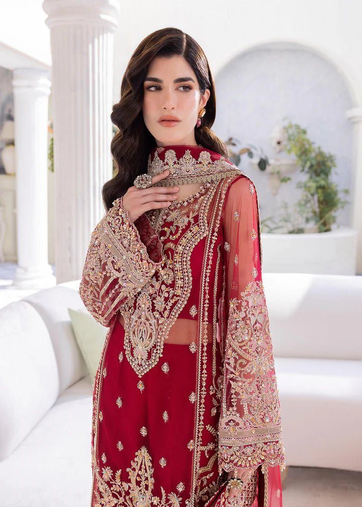 Model in Kanwal Malik MIRHA III Eid 24 Crimson dress, red suit with golden embriodery enhancing Pakistani clothes online in the UK.