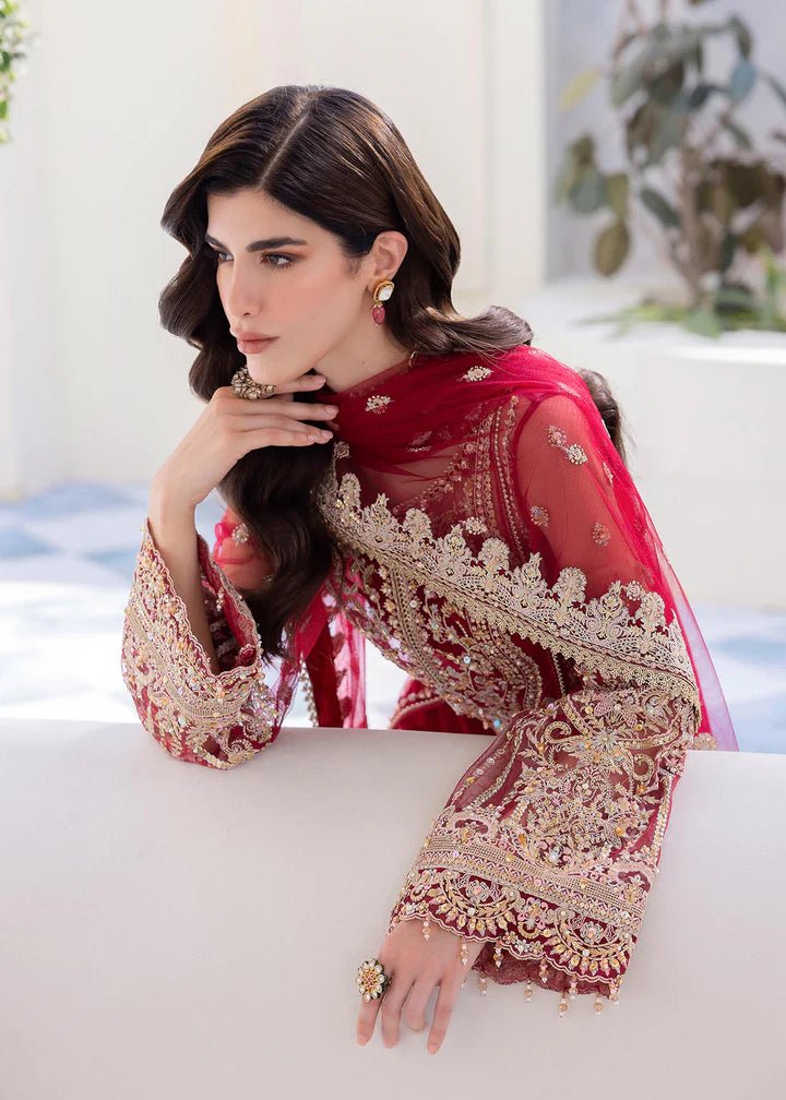 Model in Kanwal Malik MIRHA III Eid 24 Crimson dress, red suit with golden embriodery enhancing Pakistani clothes online in the UK.