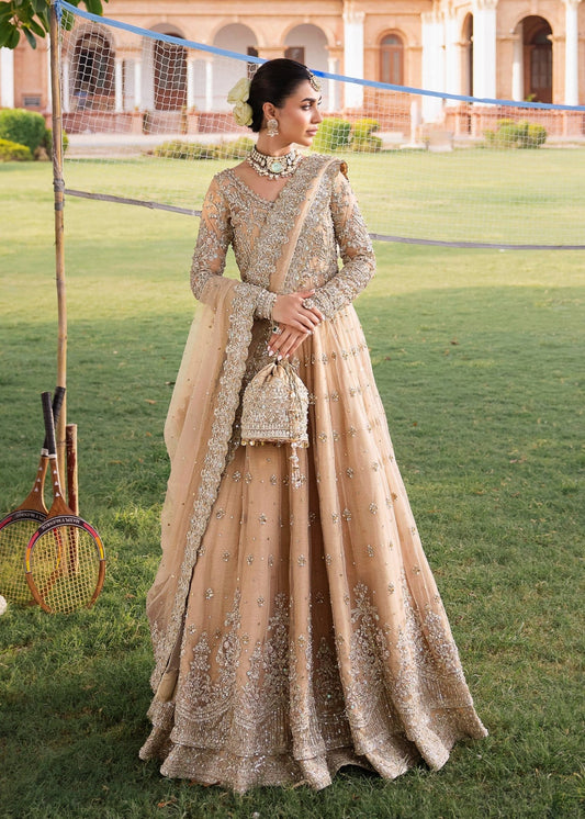 Model wearing Kanwal Malik Raaniyan Luxury Formals Jasmine dress in gold, Pakistani bridal clothes online in UK.