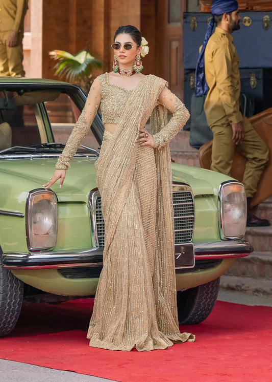 Model wearing Kanwal Malik Raaniyan Luxury Formals Mehrunisa dress in gold, Pakistani bridal clothes online in UK.