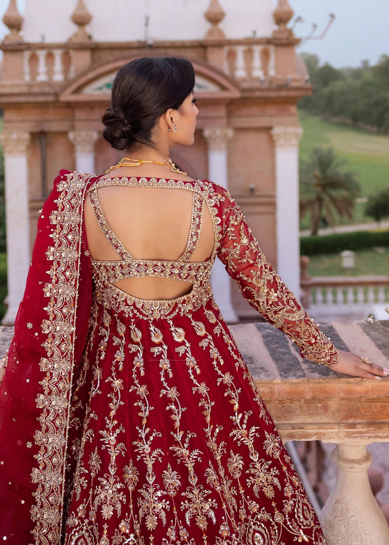 Model wearing Kanwal Malik Raaniyan Luxury Formals Zarbaft dress in deep red, Pakistani bridal clothes online in UK.