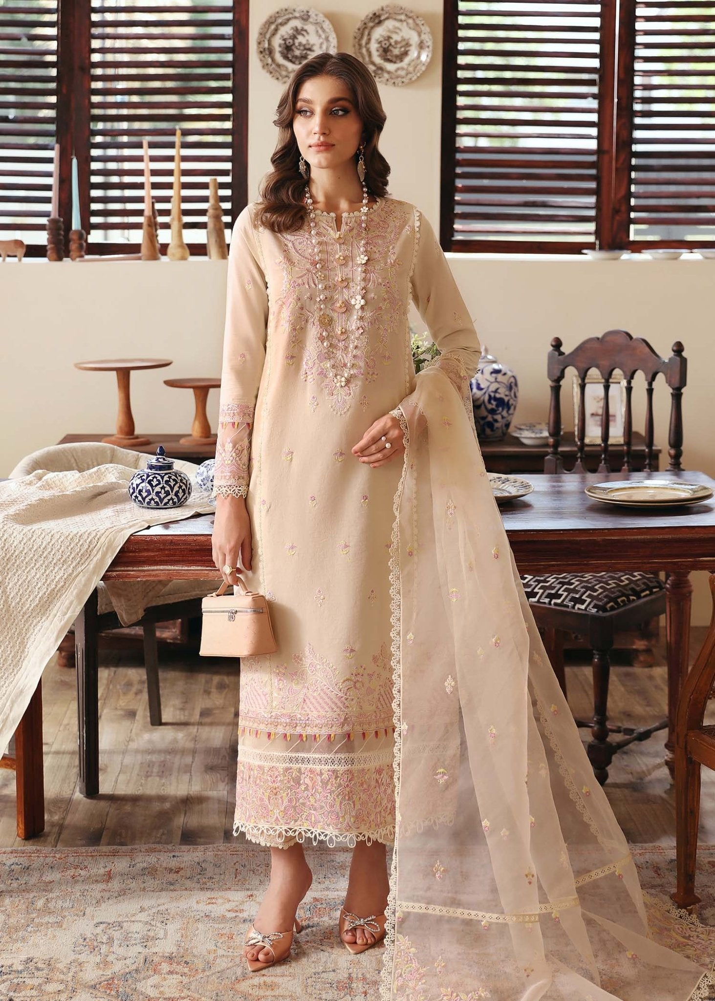 Model wearing Kanwal Malik Amelia dress in soft beige, perfect for Pakistani designer clothes in UK, readymade lawn suits, elegant and stylish attire.