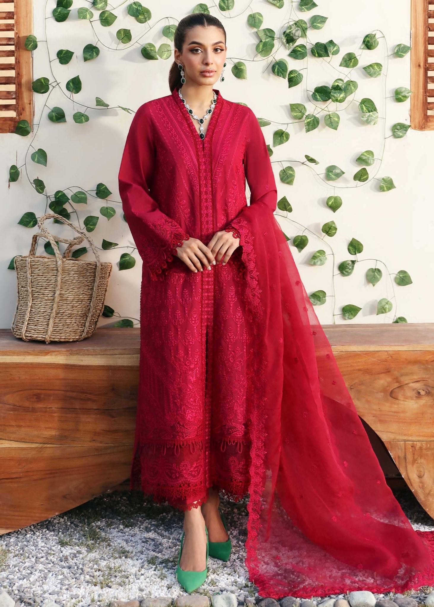 Model wearing Kanwal Malik Paula dress in vibrant red, perfect for Pakistani designer clothes in UK, readymade lawn suits.