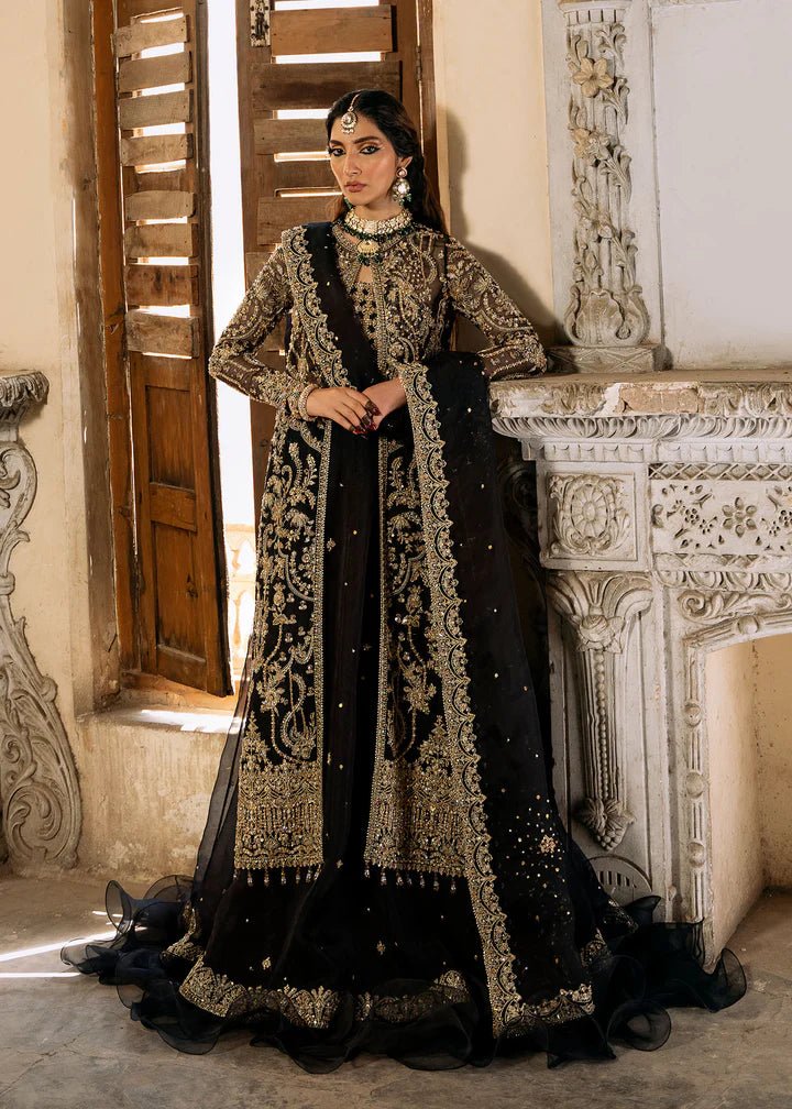 Model wearing a black and gold embellished Shahtaj formal dress from Kanwal Malik's Sajni II collection. Pakistani wedding clothes online in the UK.