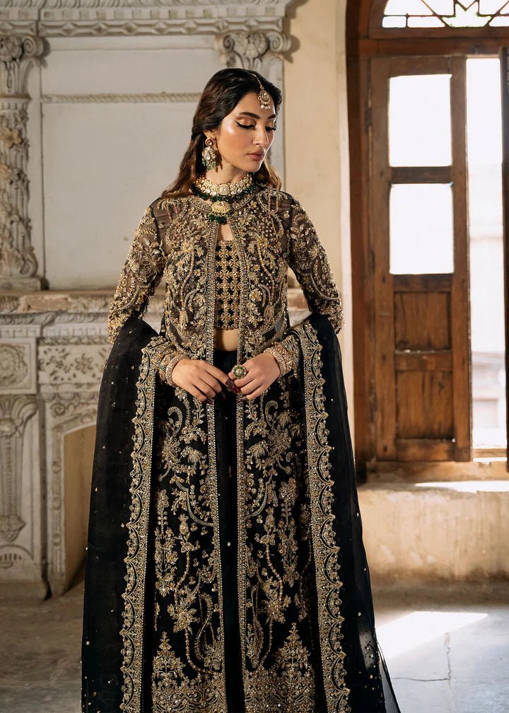 Model wearing a black and gold embellished Shahtaj formal dress from Kanwal Malik's Sajni II collection. Pakistani wedding clothes online in the UK.