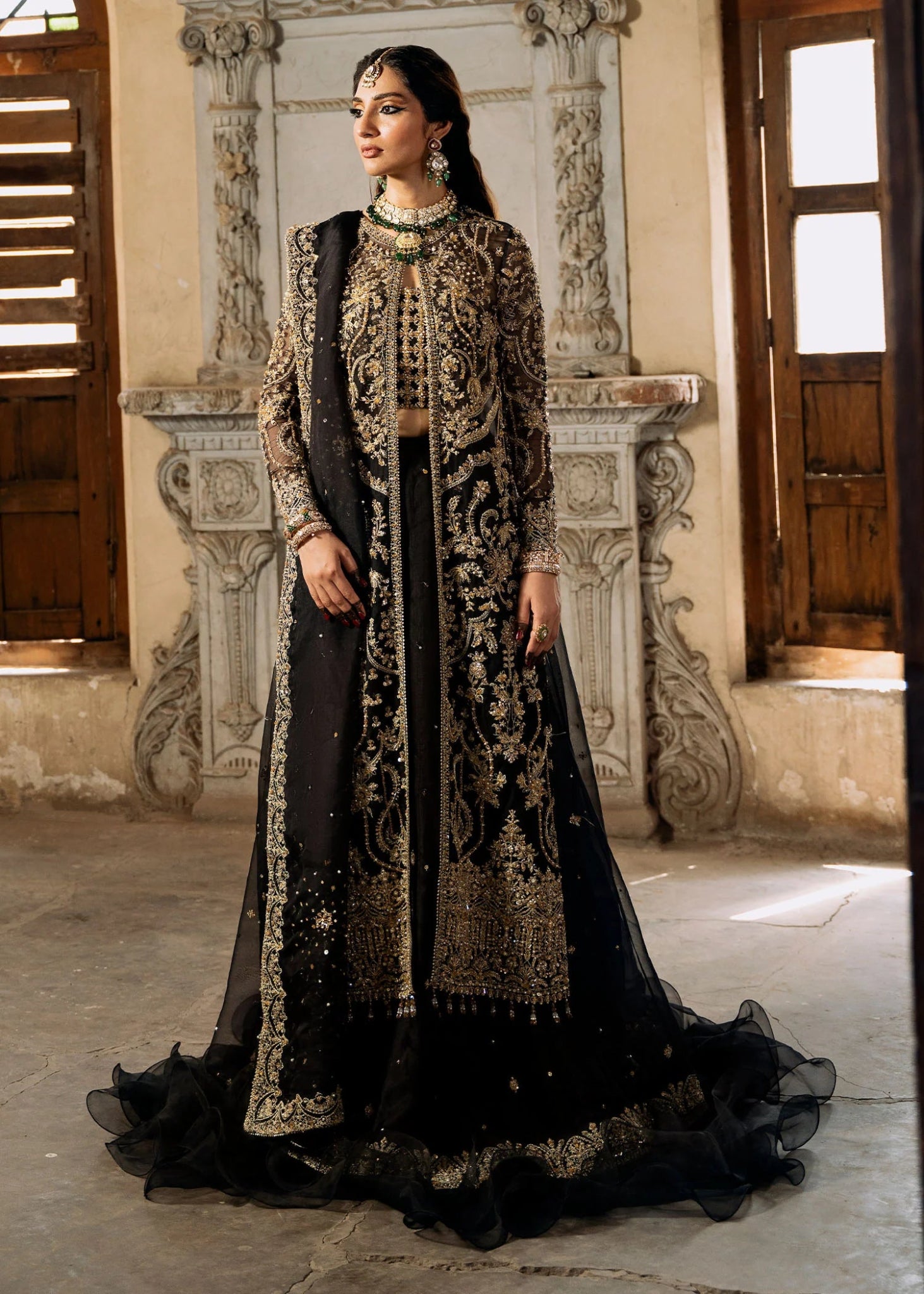 Model wearing a black and gold embellished Shahtaj formal dress from Kanwal Malik's Sajni II collection. Pakistani wedding clothes online in the UK.