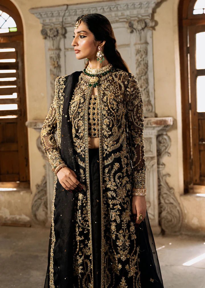 Model wearing a black and gold embellished Shahtaj formal dress from Kanwal Malik's Sajni II collection. Pakistani wedding clothes online in the UK.