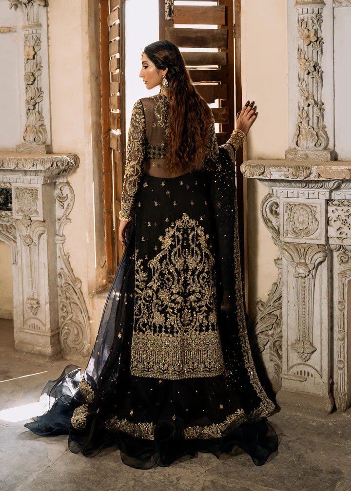 Model wearing a black and gold embellished Shahtaj formal dress from Kanwal Malik's Sajni II collection. Pakistani wedding clothes online in the UK.