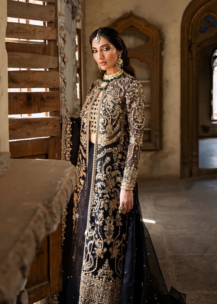 Model wearing a black and gold embellished Shahtaj formal dress from Kanwal Malik's Sajni II collection. Pakistani wedding clothes online in the UK.