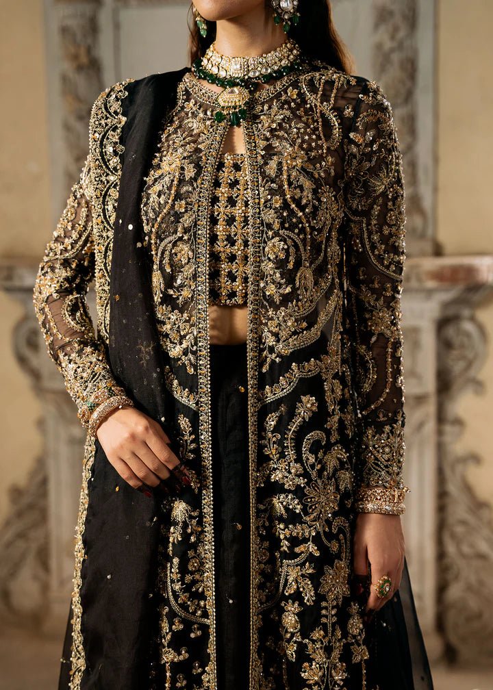 Model wearing a black and gold embellished Shahtaj formal dress from Kanwal Malik's Sajni II collection. Pakistani wedding clothes online in the UK.