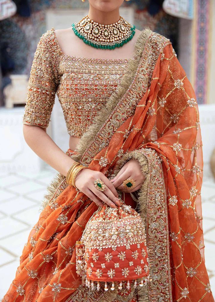 Model showcasing Kanwal Malik Vistas Of Jaipur '23 Kesar dress, enriching Pakistani wedding attire online in the UK.