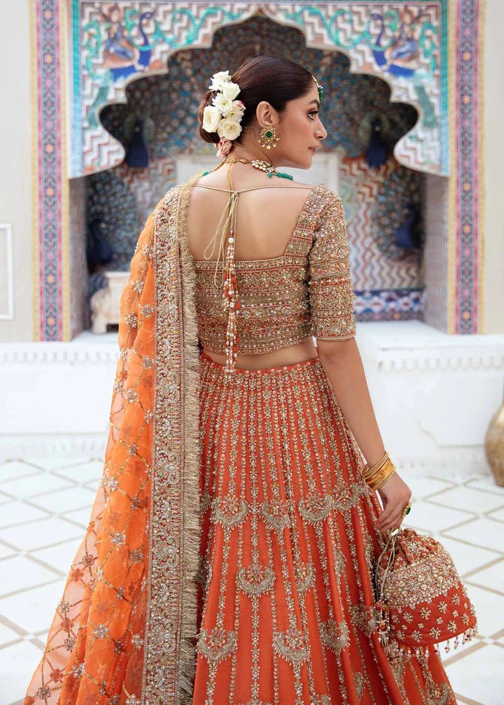 Model showcasing Kanwal Malik Vistas Of Jaipur '23 Kesar dress, enriching Pakistani wedding attire online in the UK.