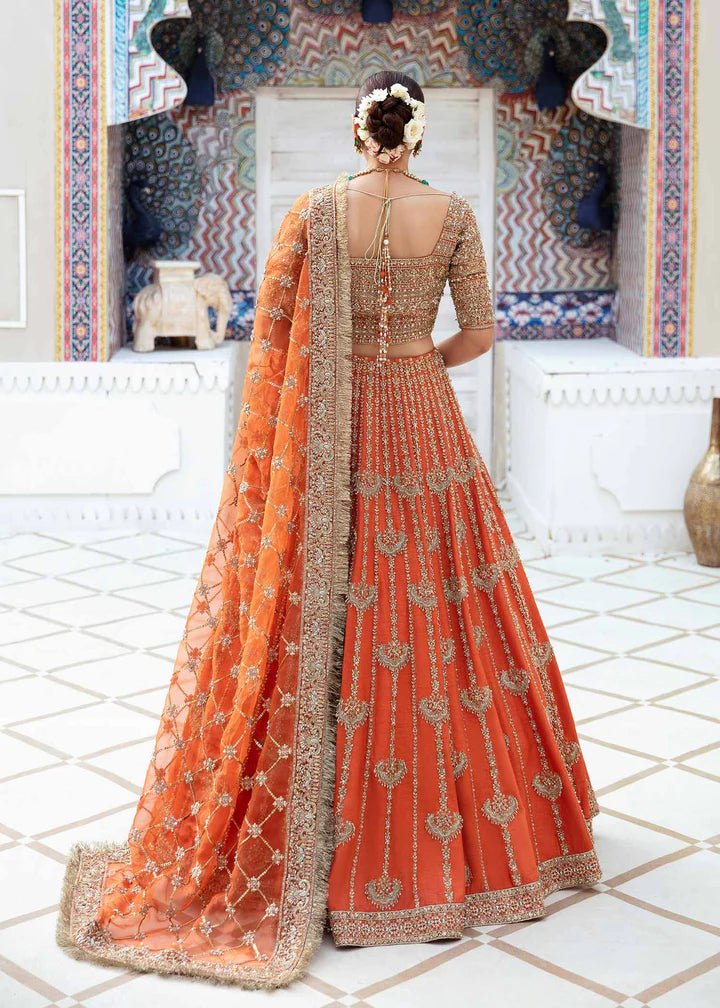 Model showcasing Kanwal Malik Vistas Of Jaipur '23 Kesar dress, enriching Pakistani wedding attire online in the UK.