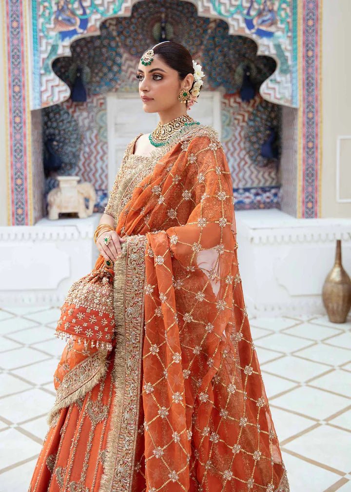 Model showcasing Kanwal Malik Vistas Of Jaipur '23 Kesar dress, enriching Pakistani wedding attire online in the UK.