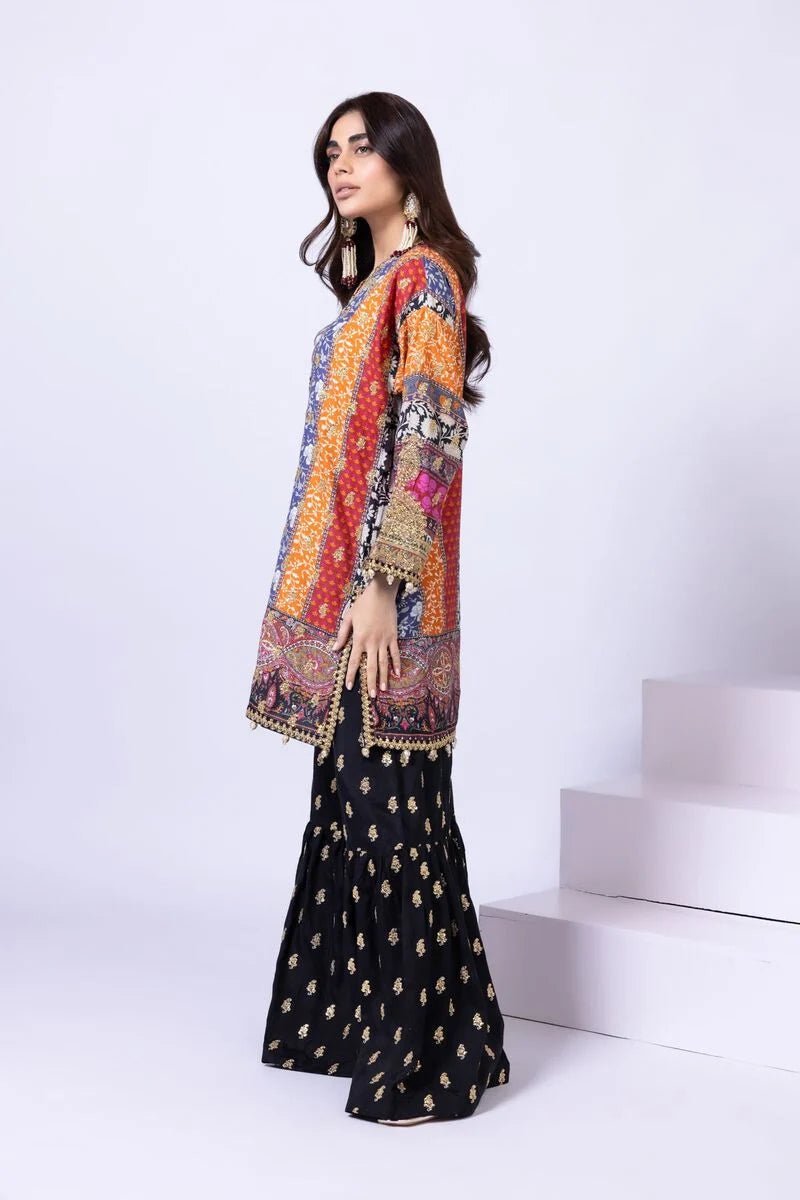 Model wearing Khaadi EST24558A multicolor dress with intricate prints and black embroidered gharara. Shop Pakistani clothes online in the UK now.