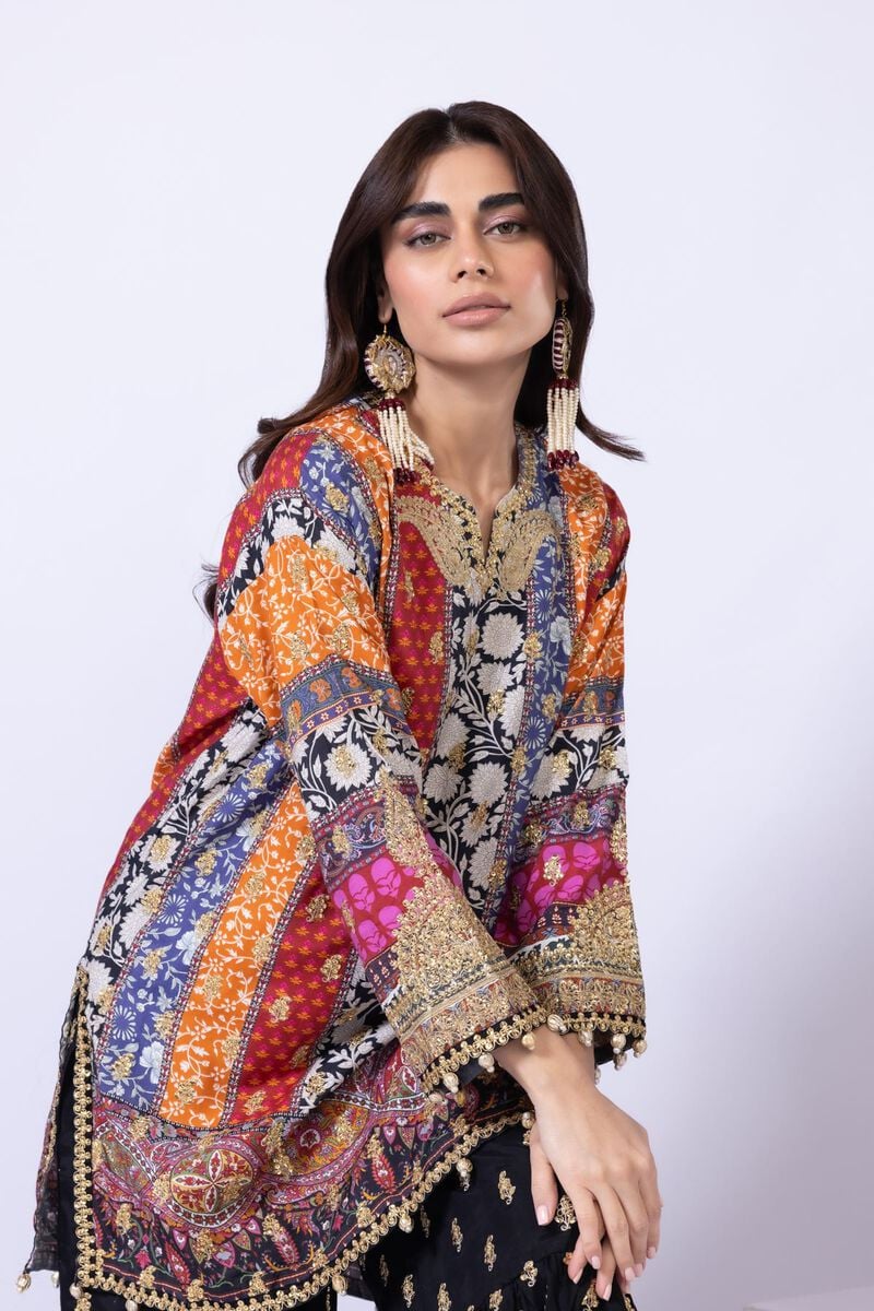 Model wearing Khaadi EST24558A multicolor dress with intricate prints and black embroidered gharara. Shop Pakistani clothes online in the UK now.