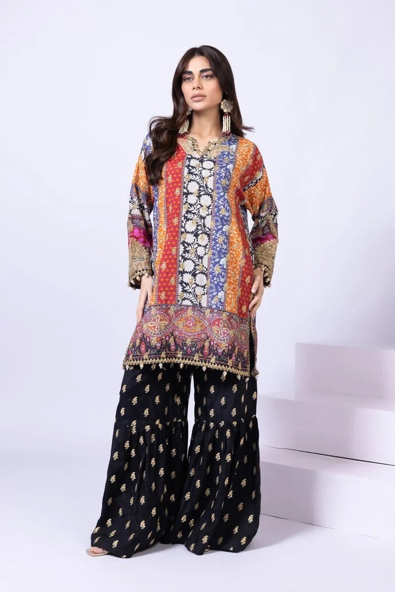 Model wearing Khaadi EST24558A multicolor dress with intricate prints and black embroidered gharara. Shop Pakistani clothes online in the UK now.