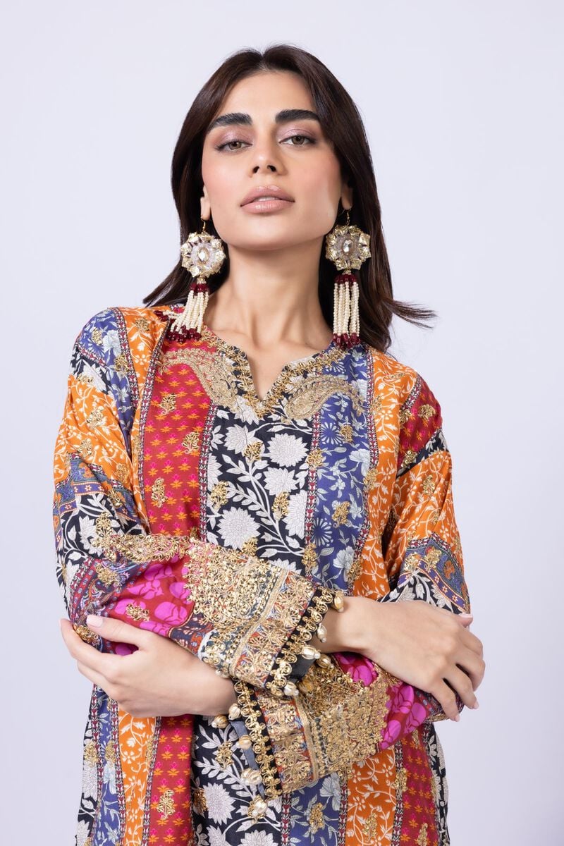 Model wearing Khaadi EST24558A multicolor dress with intricate prints and black embroidered gharara. Shop Pakistani clothes online in the UK now.