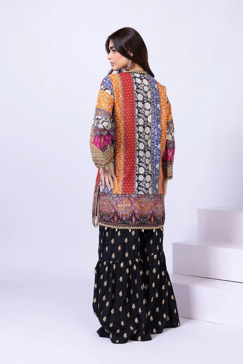 Model wearing Khaadi EST24558A multicolor dress with intricate prints and black embroidered gharara. Shop Pakistani clothes online in the UK now.