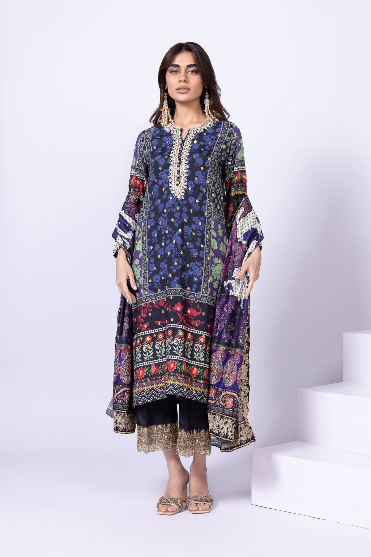 Model wearing Khaadi EST24559A navy blue dress with intricate floral and ethnic prints. Shop Pakistani clothes online in the UK now.