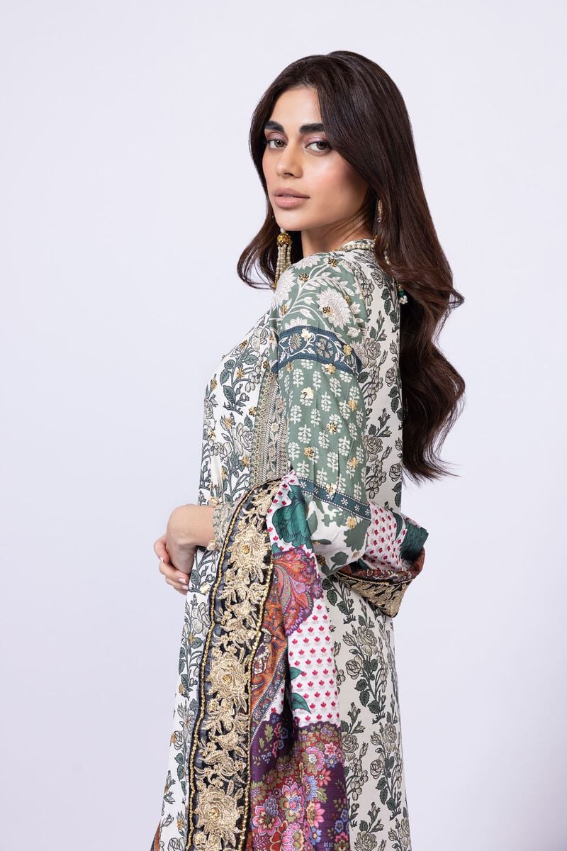 Model wearing Khaadi EST24563B off - white dress with intricate green prints and embroidered dupatta. Shop Pakistani clothes online in the UK now.