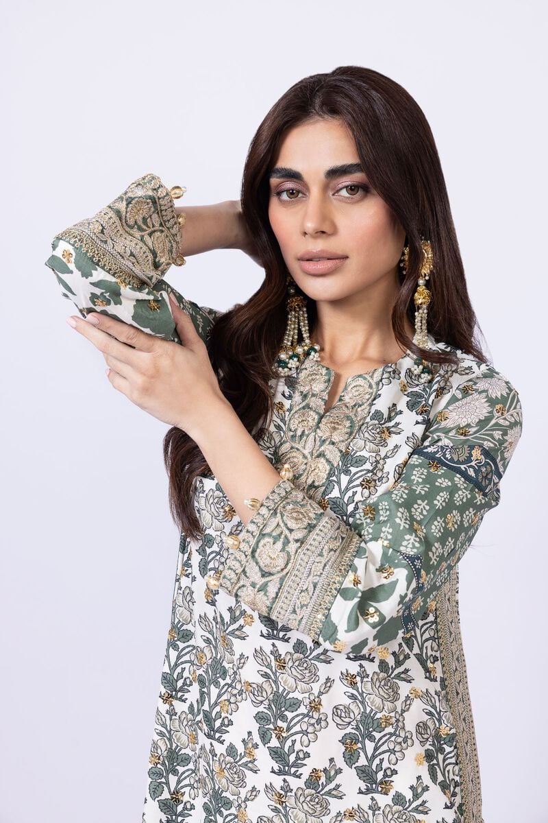 Model wearing Khaadi EST24563B off - white dress with intricate green prints and embroidered dupatta. Shop Pakistani clothes online in the UK now.