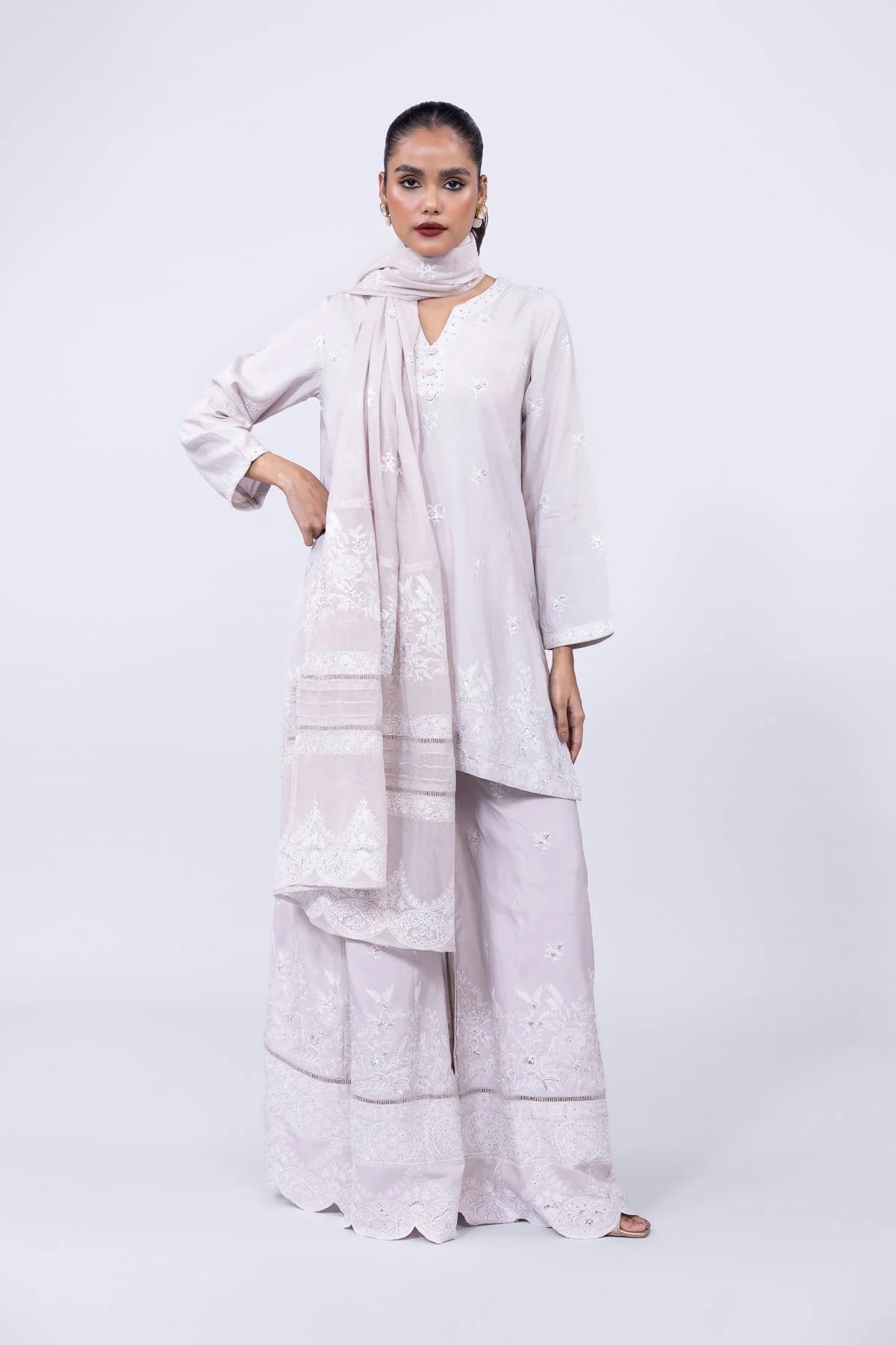 Model wearing Khaadi EST24601A beige dress with delicate white embroidery and elegant design. Shop Pakistani clothes online in the UK now.