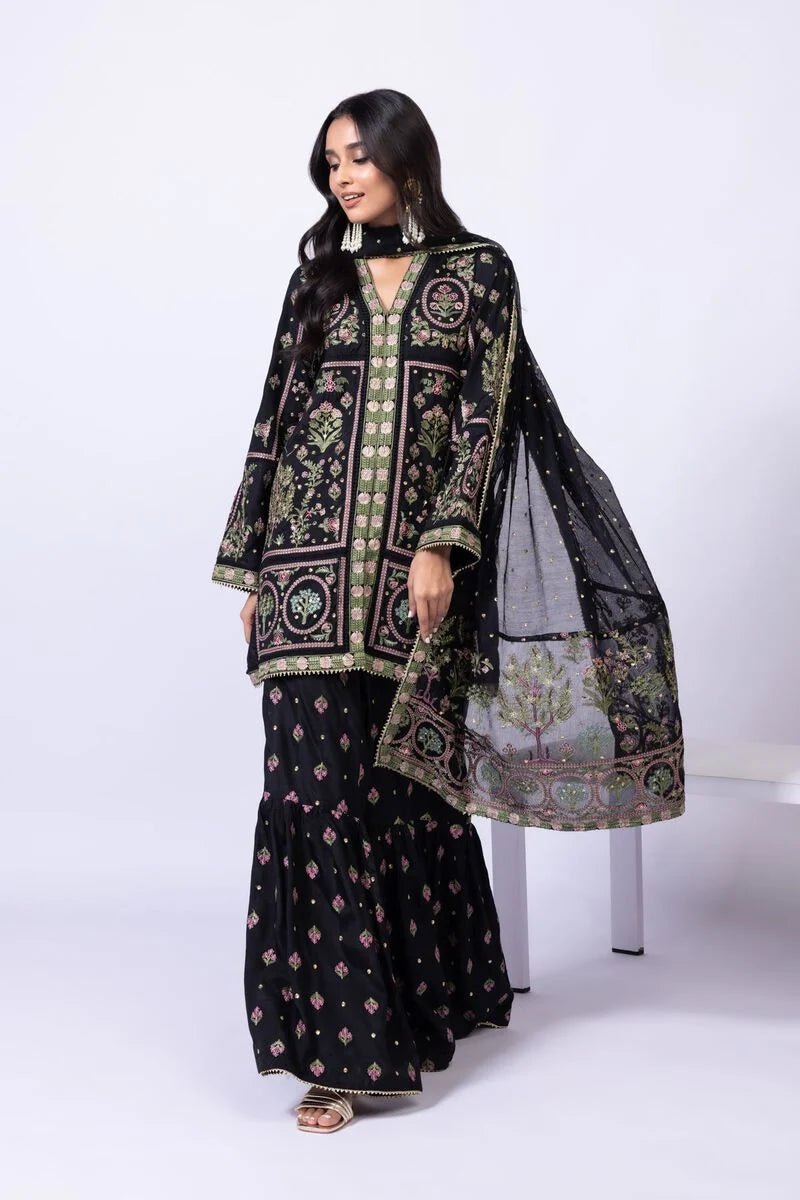 Model wearing Khaadi EST24608A black dress with intricate multicolor embroidery and gharara. Shop Pakistani clothes online in the UK now.