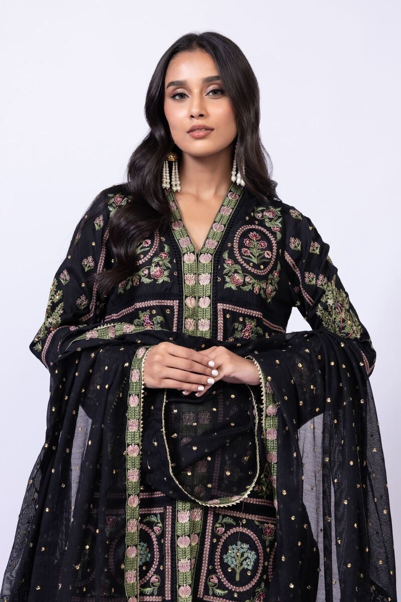 Model wearing Khaadi EST24608A black dress with intricate multicolor embroidery and gharara. Shop Pakistani clothes online in the UK now.