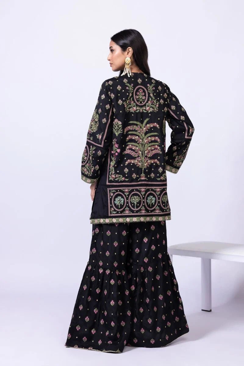 Model wearing Khaadi EST24608A black dress with intricate multicolor embroidery and gharara. Shop Pakistani clothes online in the UK now.