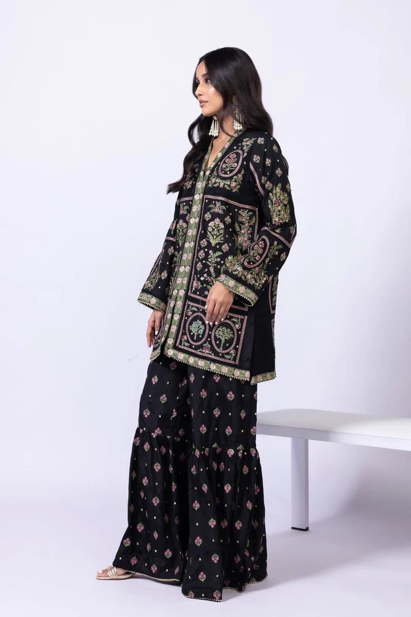 Model wearing Khaadi EST24608A black dress with intricate multicolor embroidery and gharara. Shop Pakistani clothes online in the UK now.